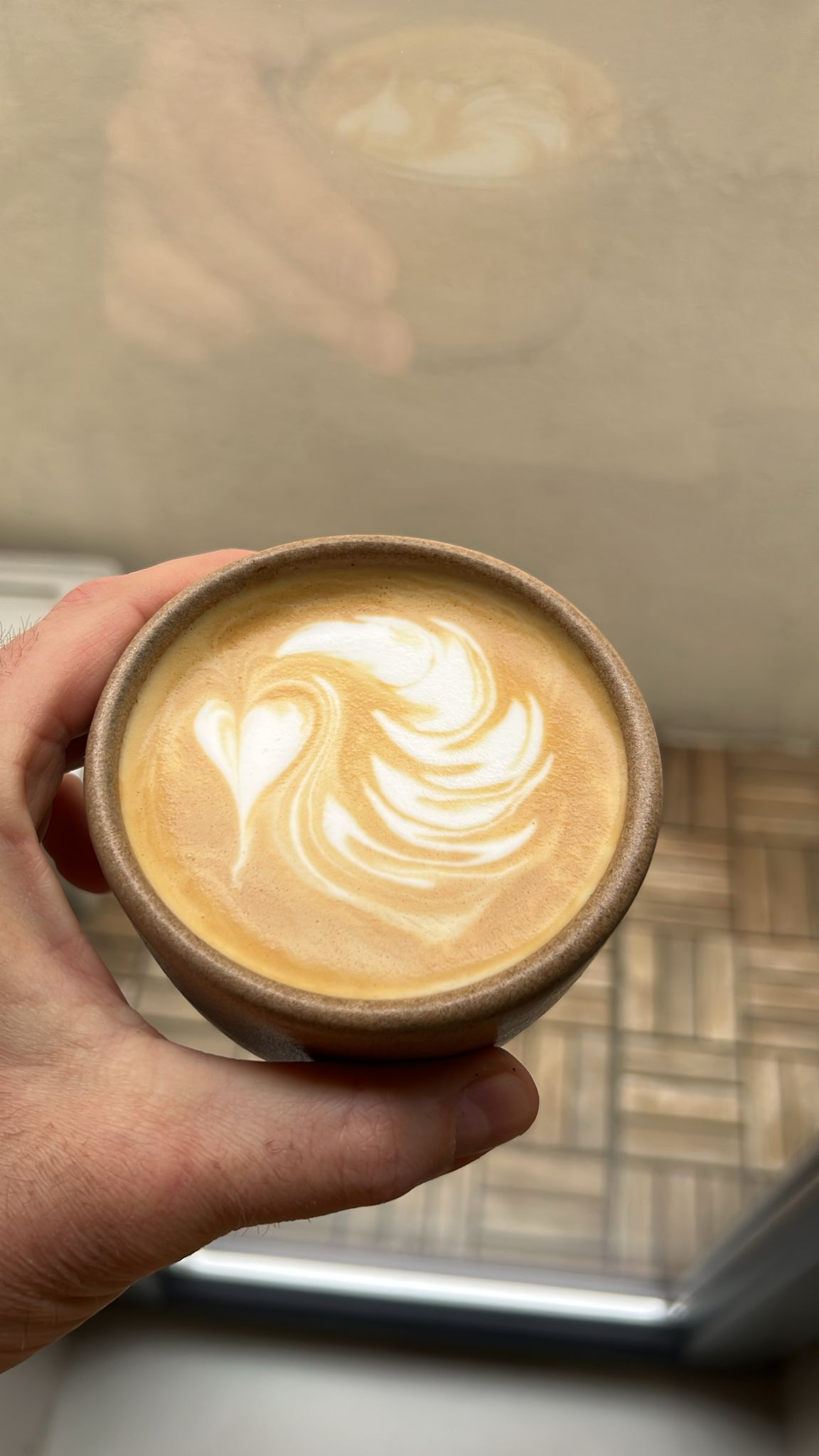 Latte art swirl with heart in an edible cup